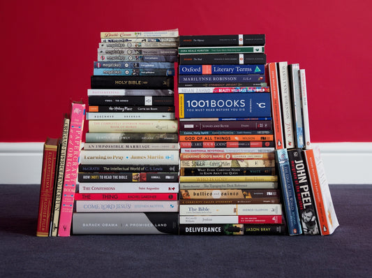 a stack of books sitting on top of a floor
