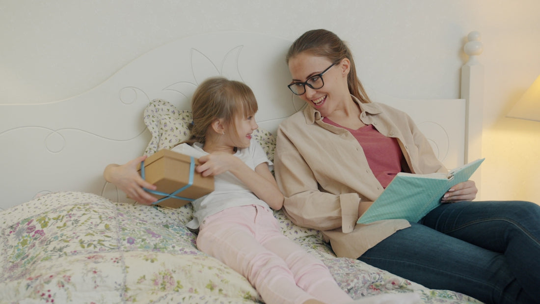 Daughter gives mother a gift while reading